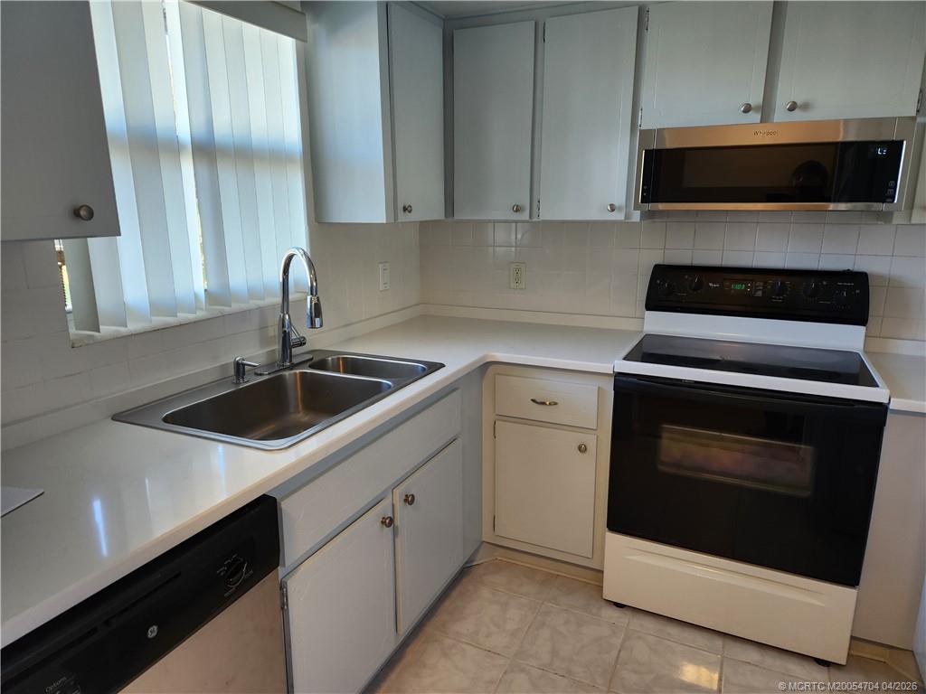 2950 Southeast Ocean Boulevard, Unit 311 Stuart, FL 34996 - Photo 9 of 16 a kitchen with a stove and a microwave