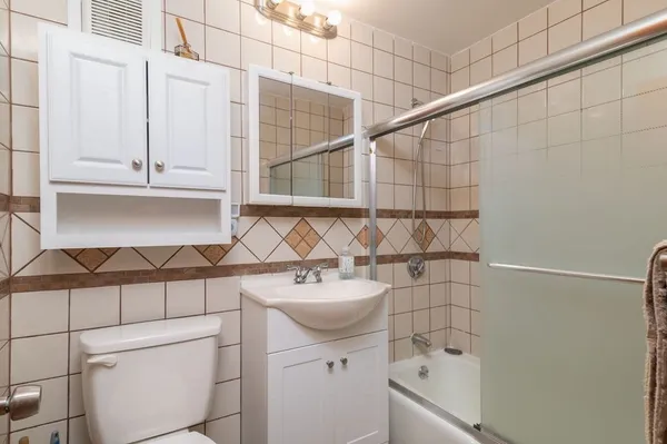 a bathroom with a sink toilet and shower