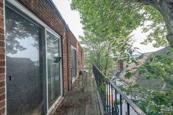 a view of balcony with wooden floor and fence