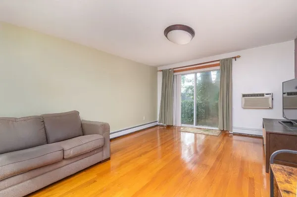 a living room with furniture and a floor to ceiling window