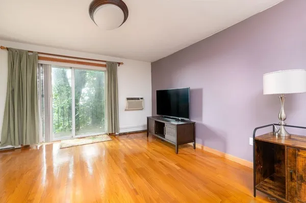 a view of a livingroom with furniture and a flat screen tv
