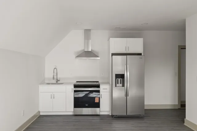 a kitchen with stainless steel appliances a refrigerator and a stove