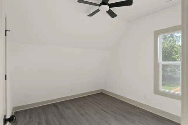 a view of a small space with wooden floor and a window