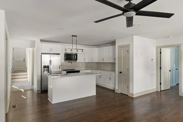 a kitchen with stainless steel appliances a refrigerator and a stove
