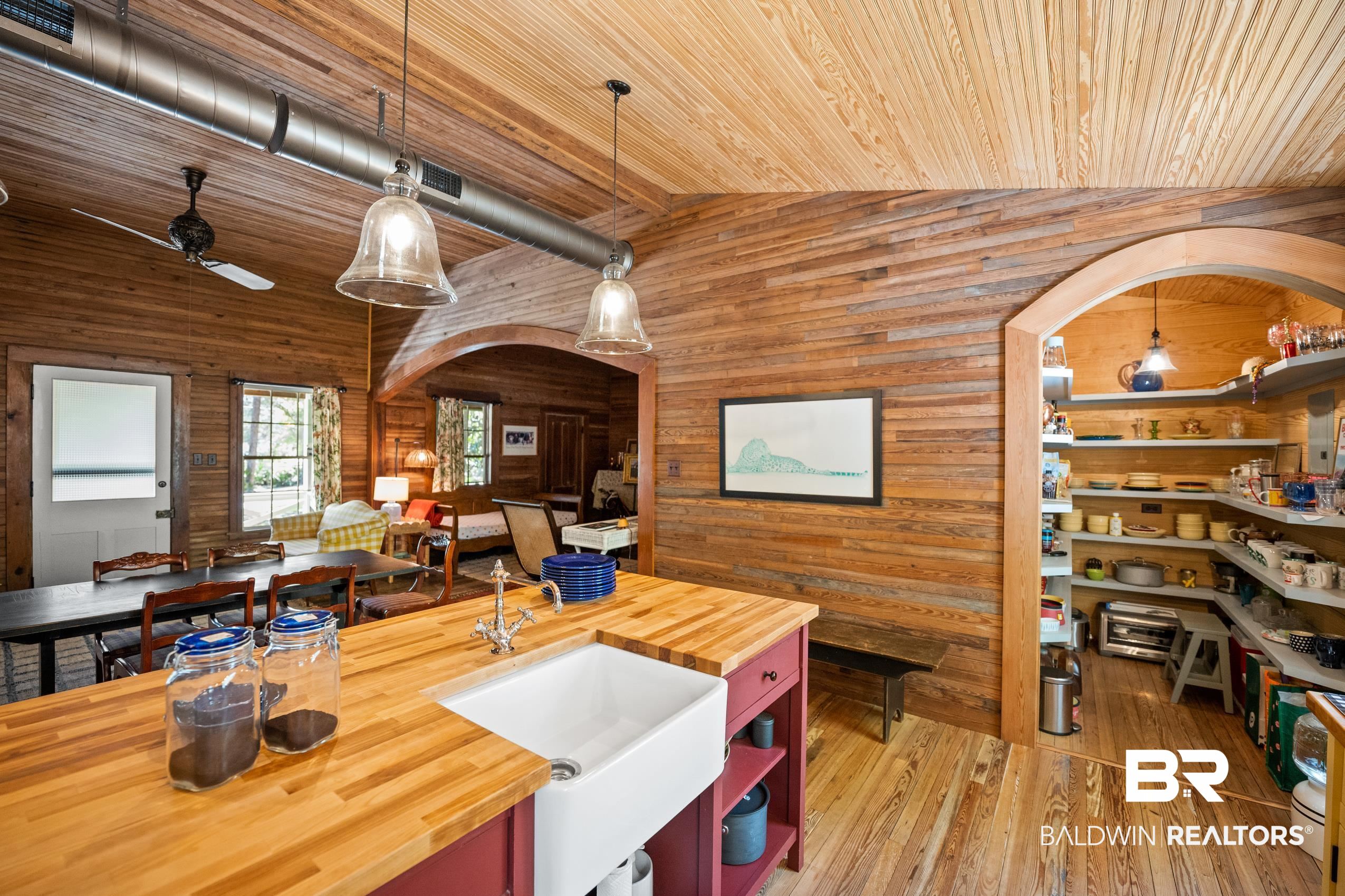 30671 Magnolia Street Elberta, AL 36530 - Photo 68 of 68 Kitchen featuring wood walls, wood counters, open floor plan, vaulted ceiling, and wood ceiling