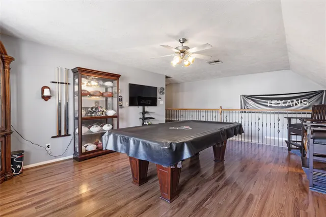 a living room with a table chairs and a refrigerator
