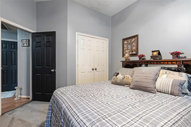 a bedroom with a large bed and a chandelier