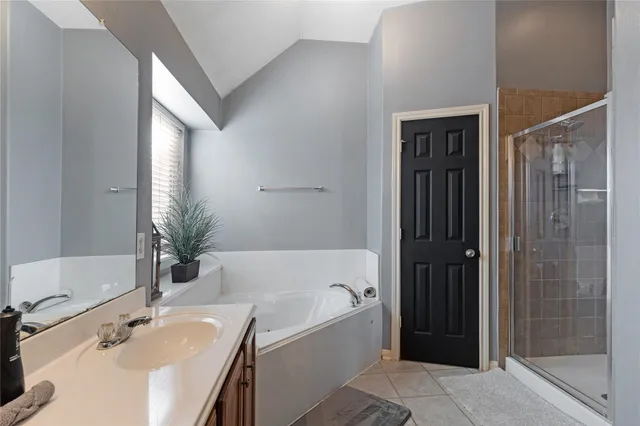 a bathroom with a tub shower and sink