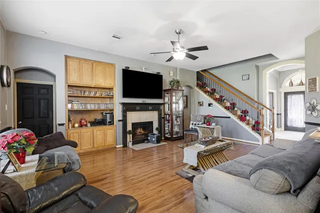 a living room with furniture fireplace and flat screen tv