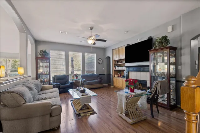 a living room with furniture a fireplace and a flat screen tv