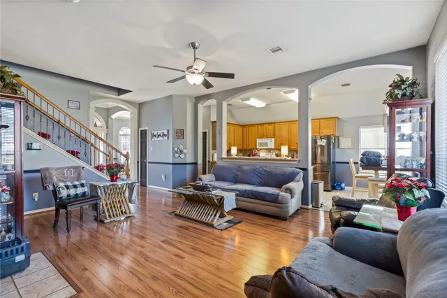 a living room with furniture and wooden floor