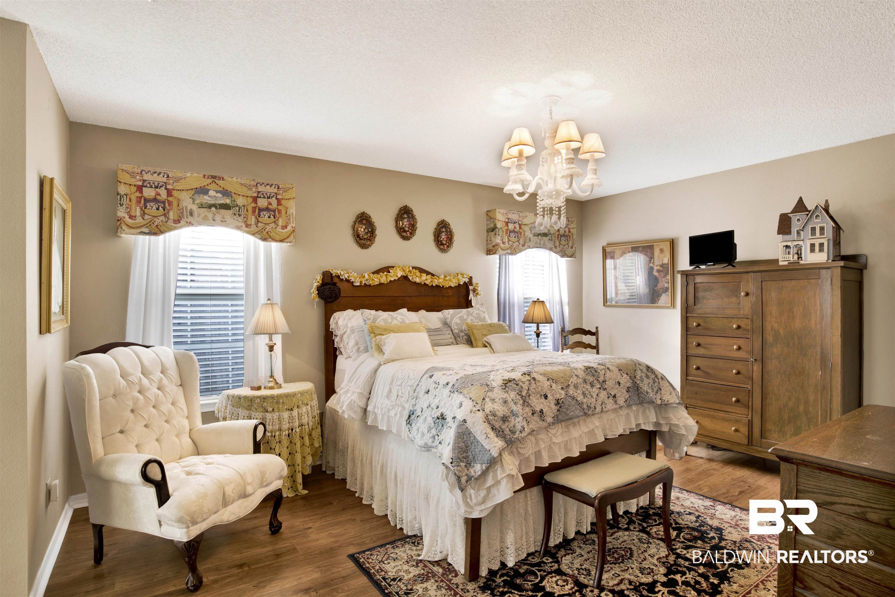 11697 Balsam Court Daphne, AL 36527 - Photo 17 of 31 Bedroom featuring multiple windows, hardwood / wood-style floors, and an inviting chandelier