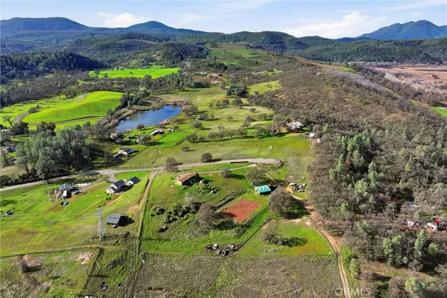a view of a lush green hillside and houses