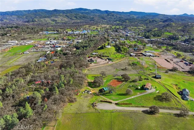 an aerial view of a residential houses with outdoor space