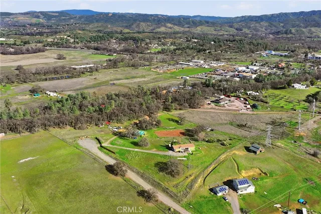 an aerial view of residential houses with outdoor space and river