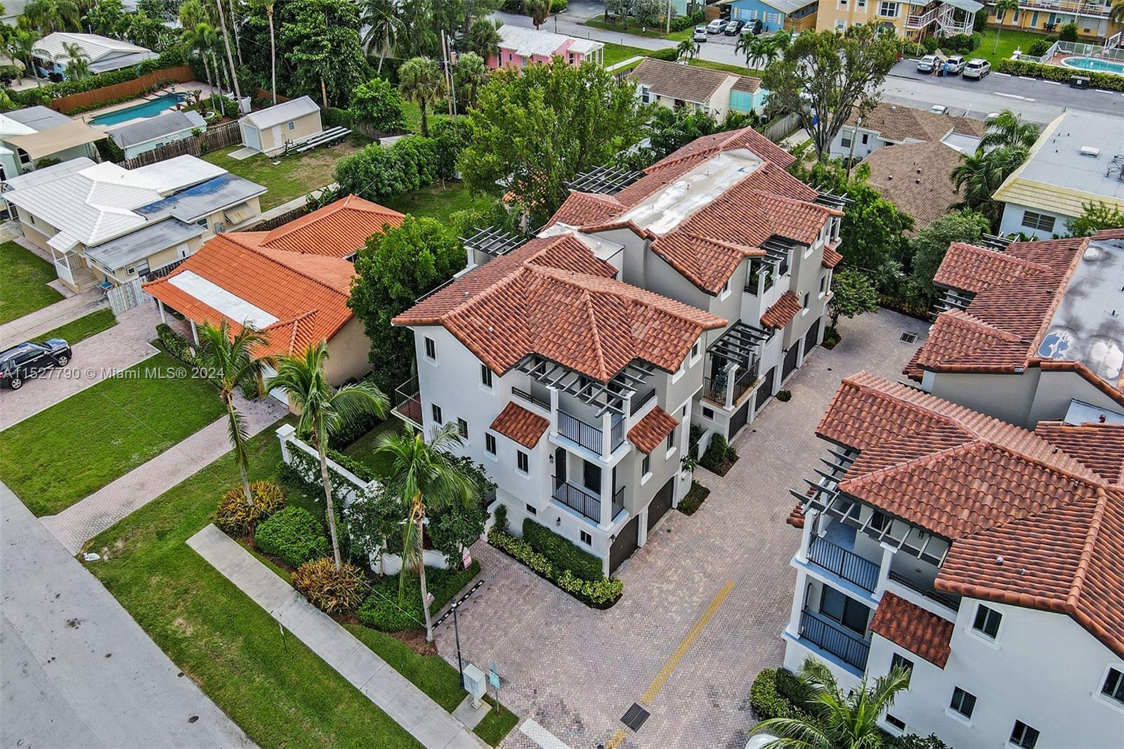 an aerial view of houses with yard