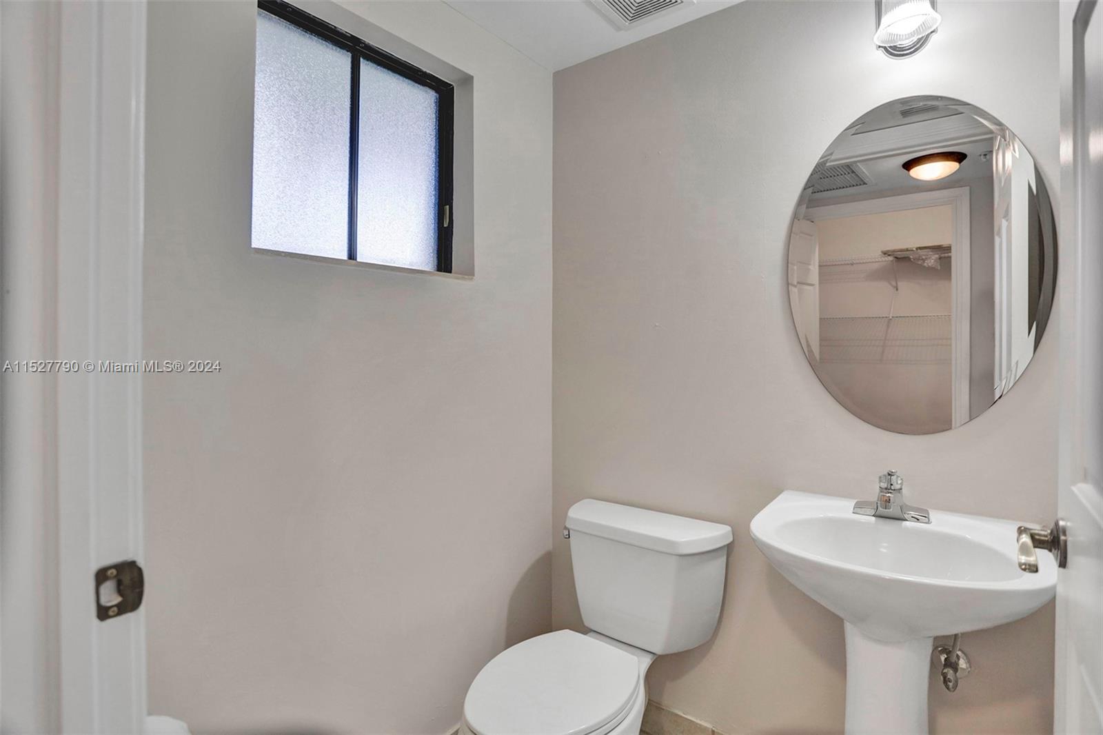 Ocean Vue Deerfield Beach, FL 33441 - Photo 26 of 93 a bathroom with a toilet sink and mirror