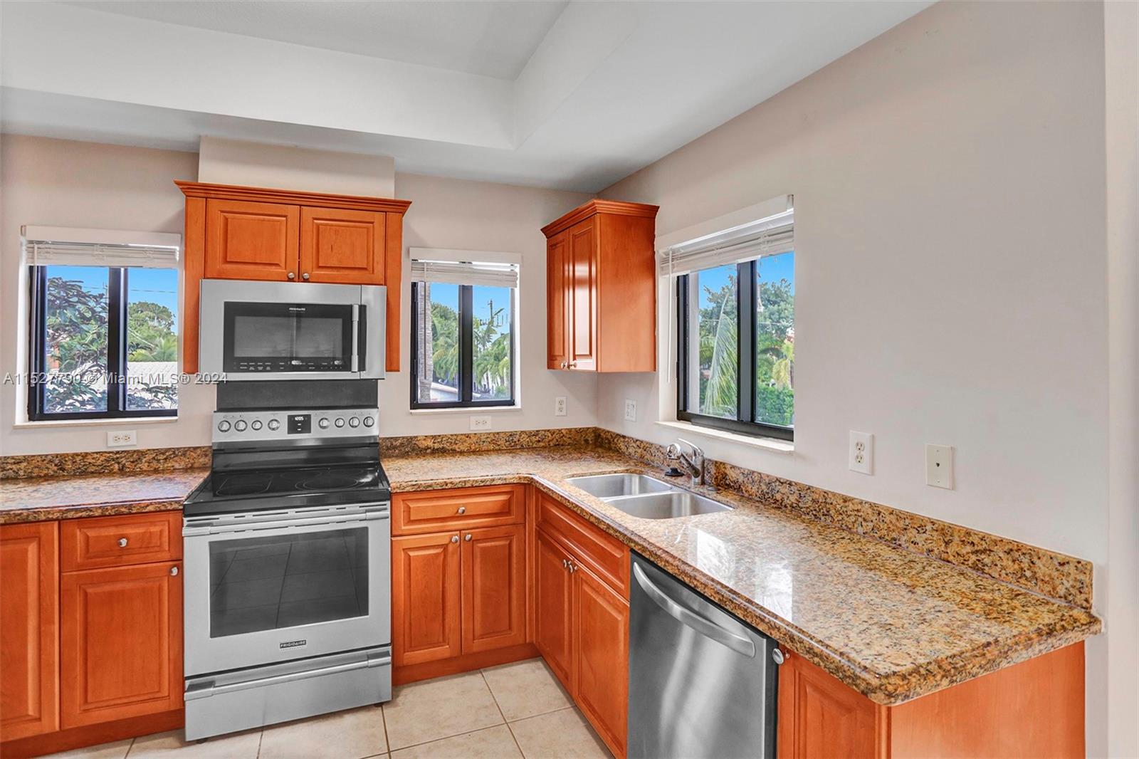 Ocean Vue Deerfield Beach, FL 33441 - Photo 33 of 93 a kitchen with granite countertop a stove sink and microwave