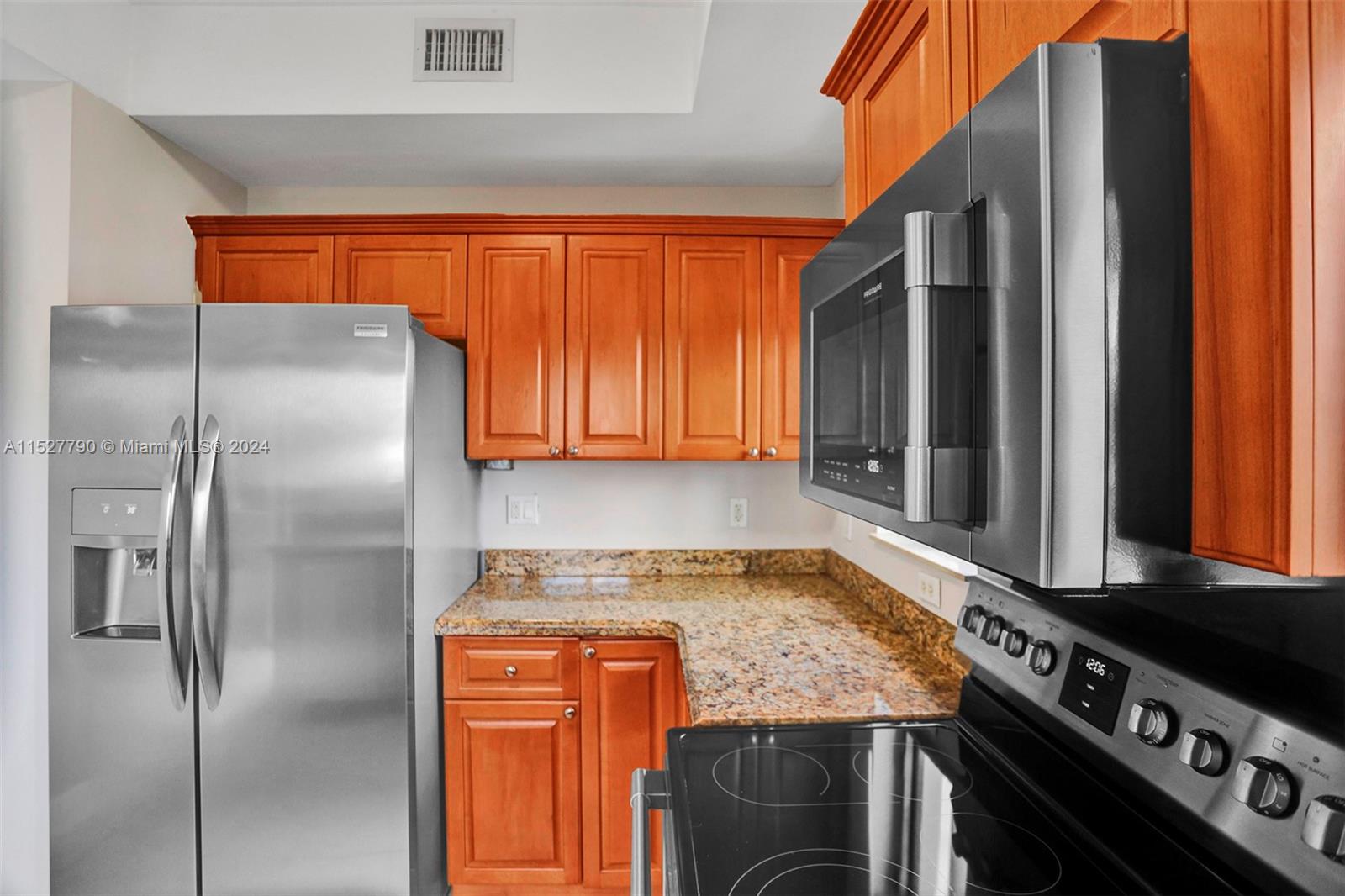 Ocean Vue Deerfield Beach, FL 33441 - Photo 34 of 93 a kitchen with stainless steel appliances granite countertop a refrigerator and a stove