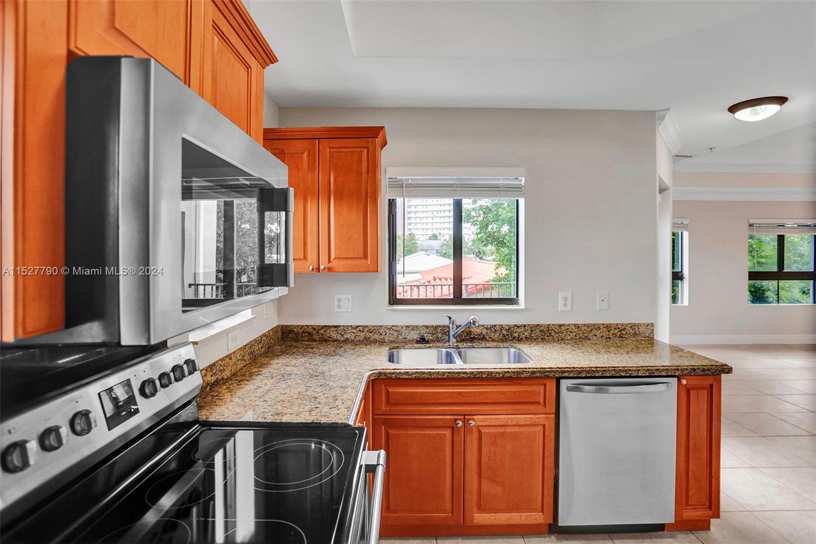 Ocean Vue Deerfield Beach, FL 33441 - Photo 35 of 93 a kitchen with stainless steel appliances granite countertop a sink stove and cabinets