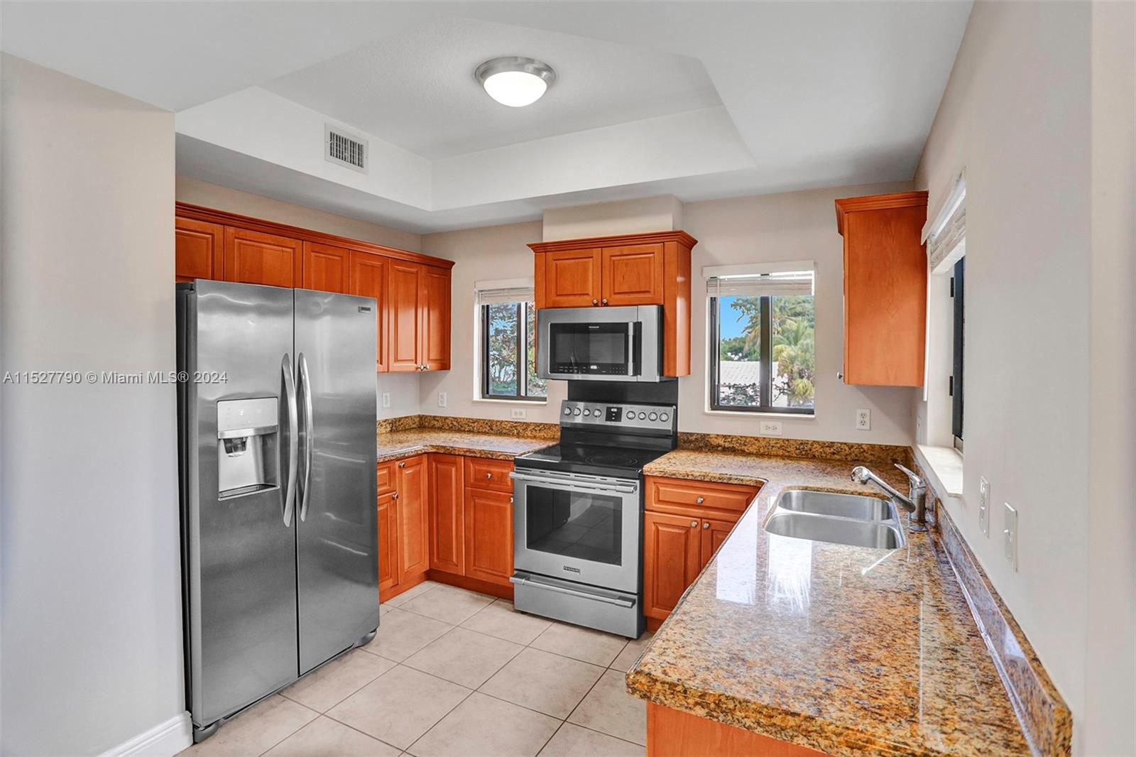 Ocean Vue Deerfield Beach, FL 33441 - Photo 36 of 93 a kitchen with stainless steel appliances granite countertop a refrigerator a stove and a sink with wooden floor
