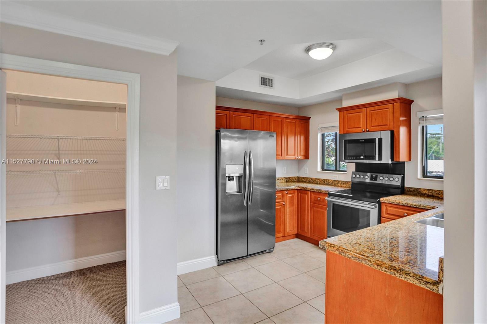 Ocean Vue Deerfield Beach, FL 33441 - Photo 37 of 93 a kitchen with stainless steel appliances granite countertop a refrigerator and a stove