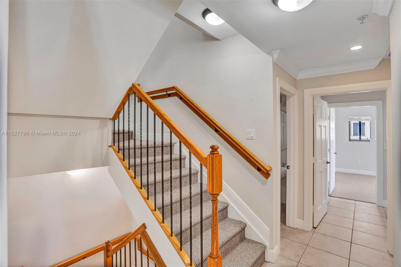 Ocean Vue Deerfield Beach, FL 33441 - Photo 38 of 93 a view of staircase with lots of frames on wall and wooden floor