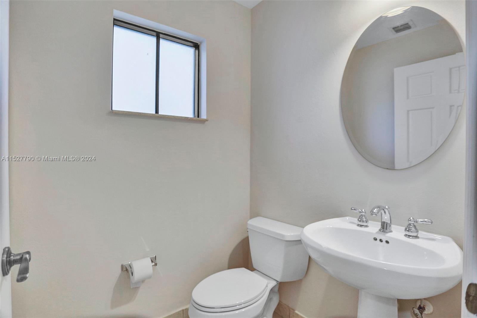 Ocean Vue Deerfield Beach, FL 33441 - Photo 39 of 93 a bathroom with a sink a mirror and a toilet