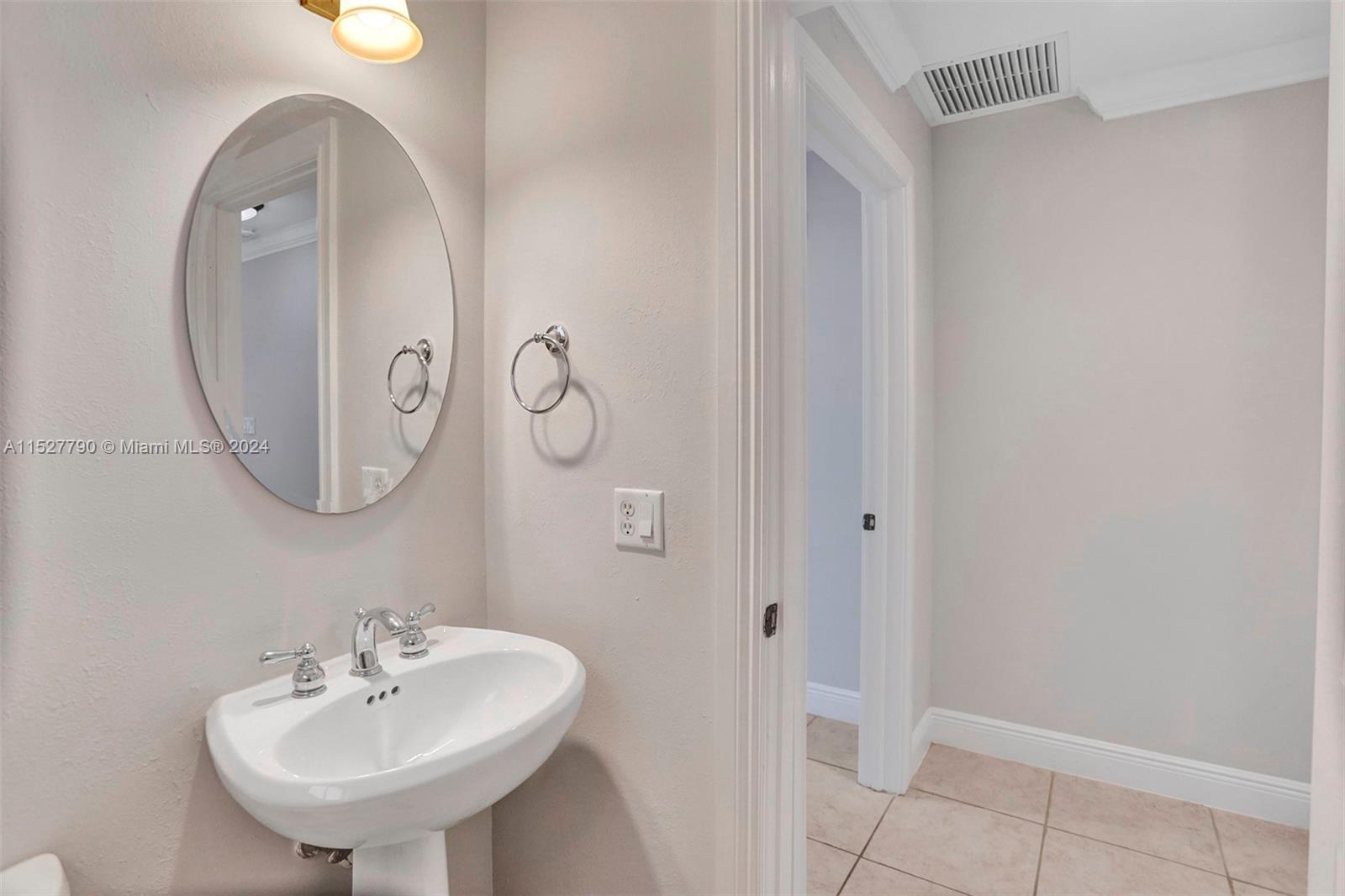 Ocean Vue Deerfield Beach, FL 33441 - Photo 40 of 93 a bathroom with a sink and a mirror