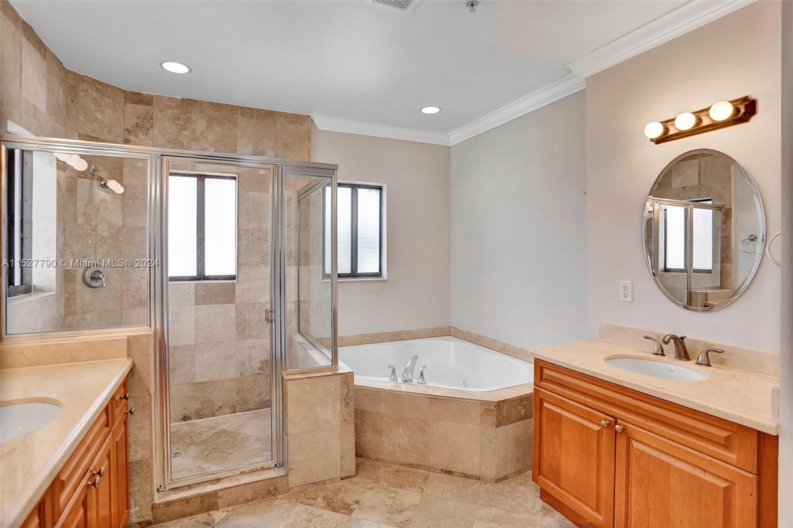 Ocean Vue Deerfield Beach, FL 33441 - Photo 65 of 93 a bathroom with a tub sink and mirror