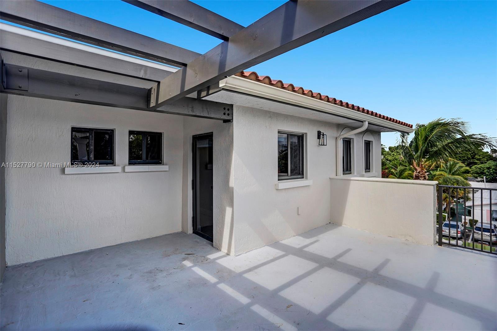 Ocean Vue Deerfield Beach, FL 33441 - Photo 77 of 93 a view of a white house with a potted plant and a window