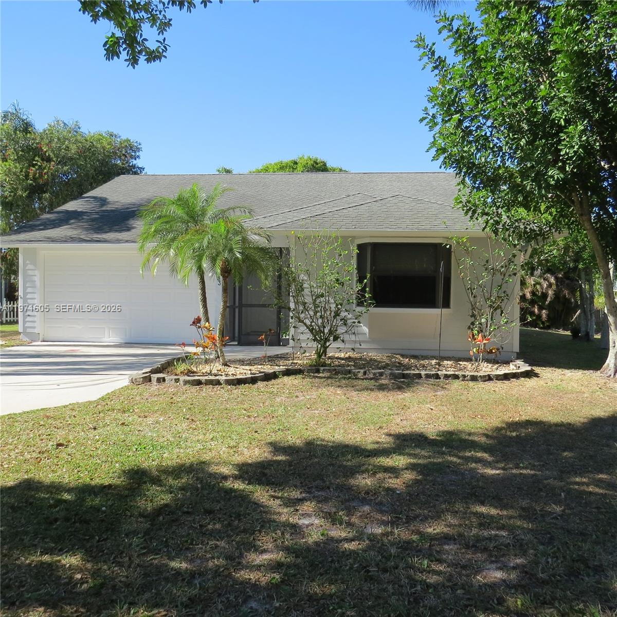 6883 Southeast Raintree Avenue Stuart, FL 34997 - Photo 1 of 32 a view of a swimming pool with a yard