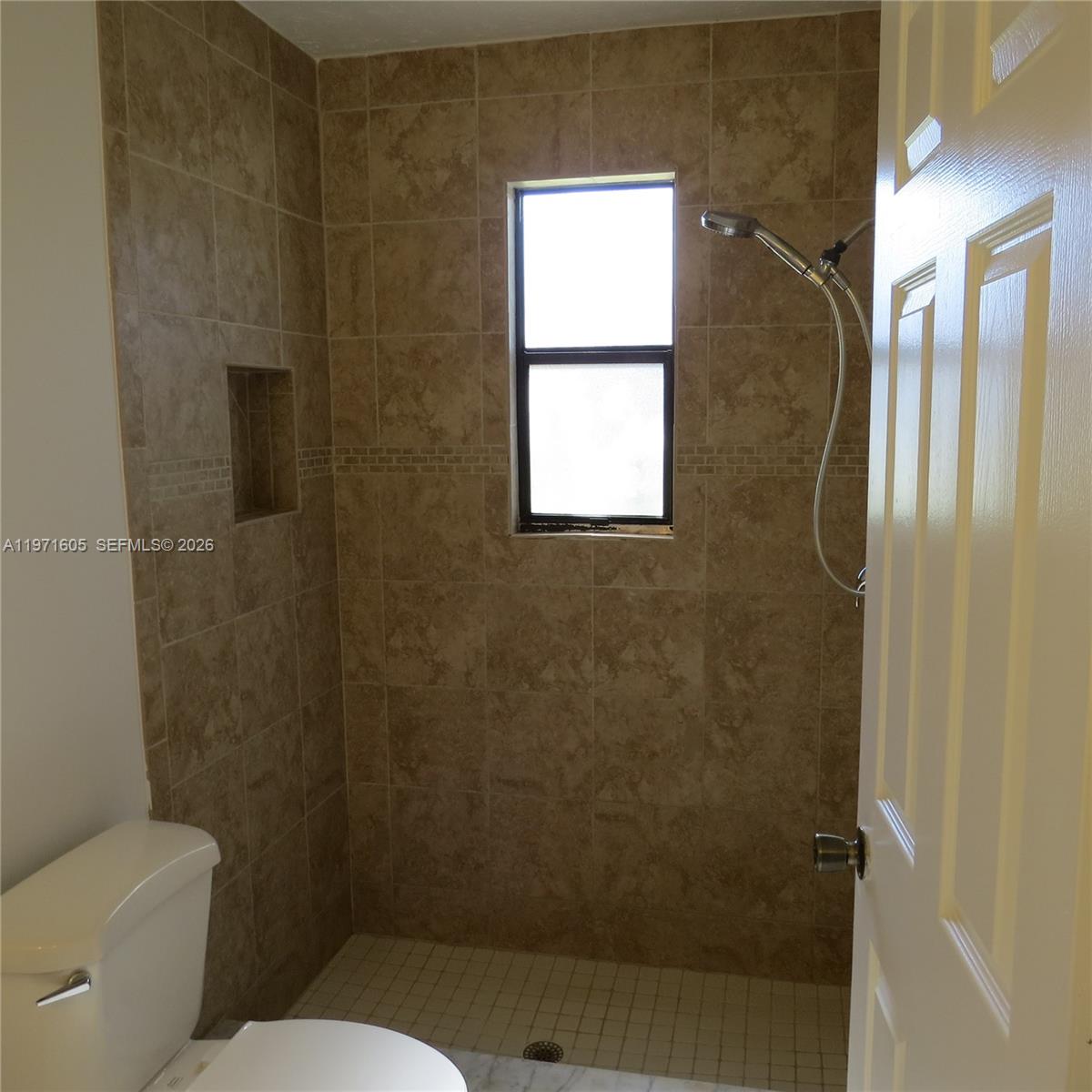 6883 Southeast Raintree Avenue Stuart, FL 34997 - Photo 14 of 32 a bathroom with a toilet and a shower