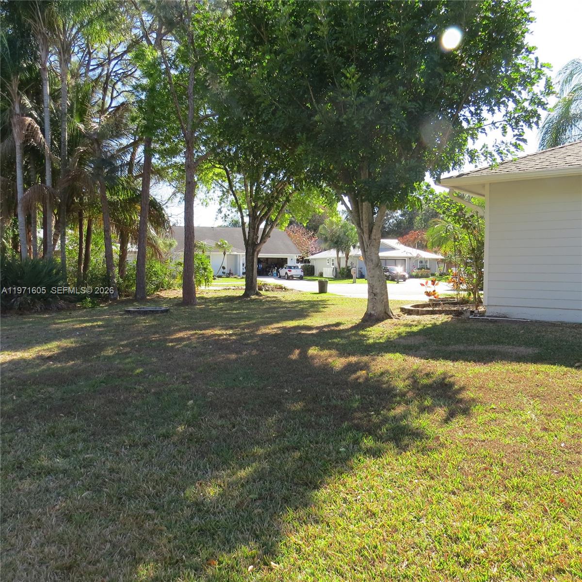 6883 Southeast Raintree Avenue Stuart, FL 34997 - Photo 22 of 32 a view of yard with tree and green space