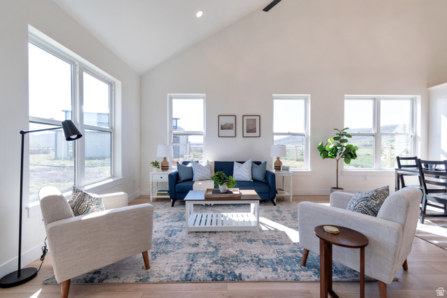 1820 West Farmhouse Flats Road Peoa, UT 84061 - Photo 61 of 79 Vaulted ceilings enhance the bright living area, featuring multiple large windows, recessed lighting, and wood-finish flooring