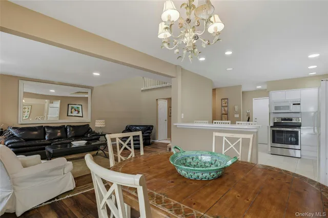a dining room with furniture a large window and wooden floor