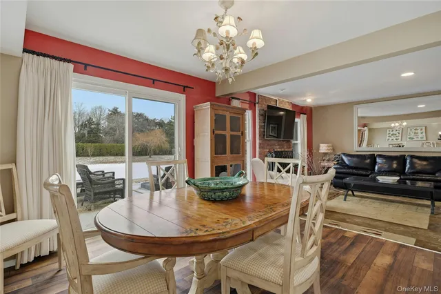 a dining room with furniture a chandelier and fireplace