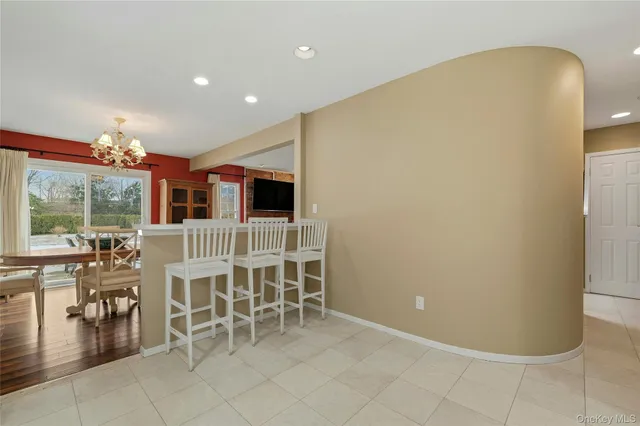 a kitchen with white cabinets stainless steel appliances and a window