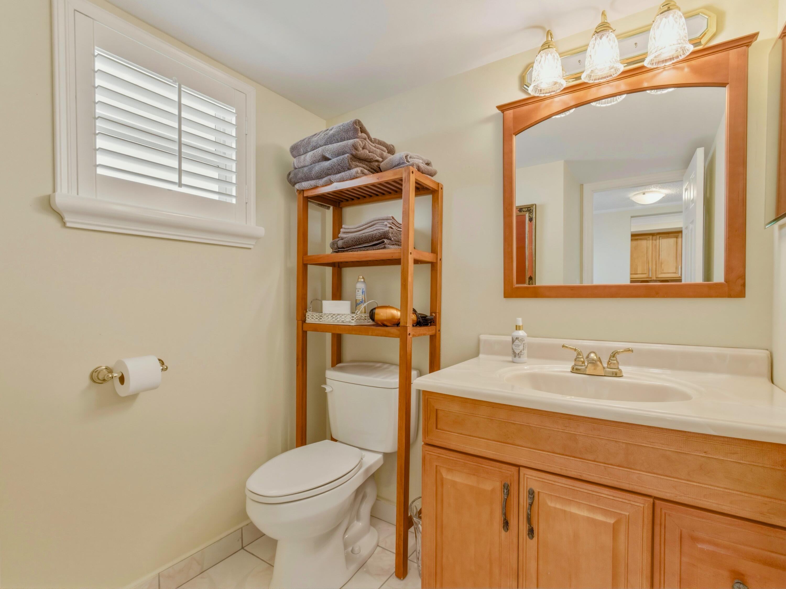 9810 Marina Boulevard, Unit 1136 Boca Raton, FL 33428 - Photo 12 of 35 a bathroom with a sink a toilet and mirror