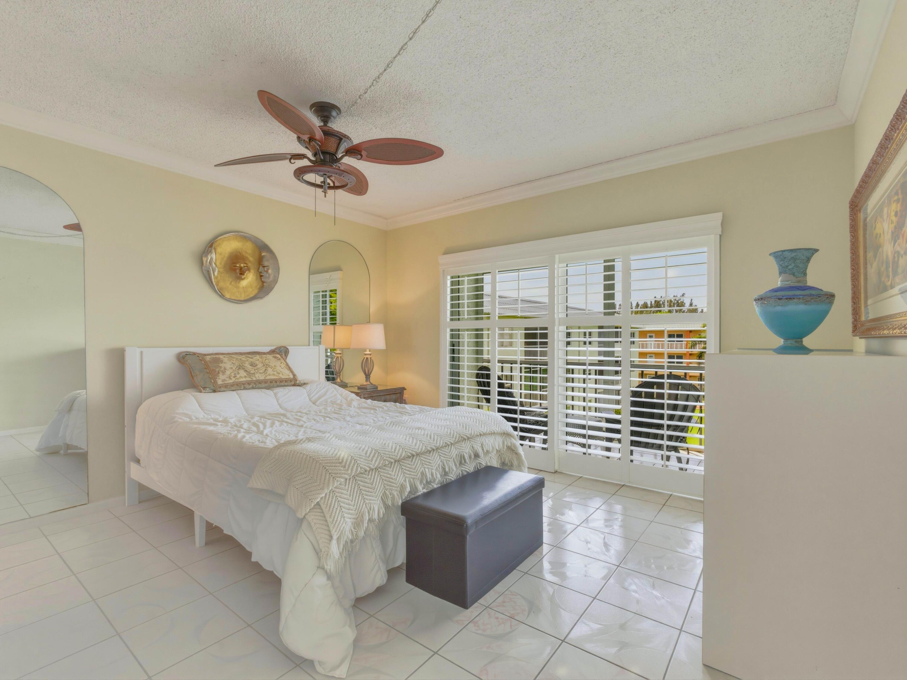 9810 Marina Boulevard, Unit 1136 Boca Raton, FL 33428 - Photo 14 of 35 a bedroom with a bed and window