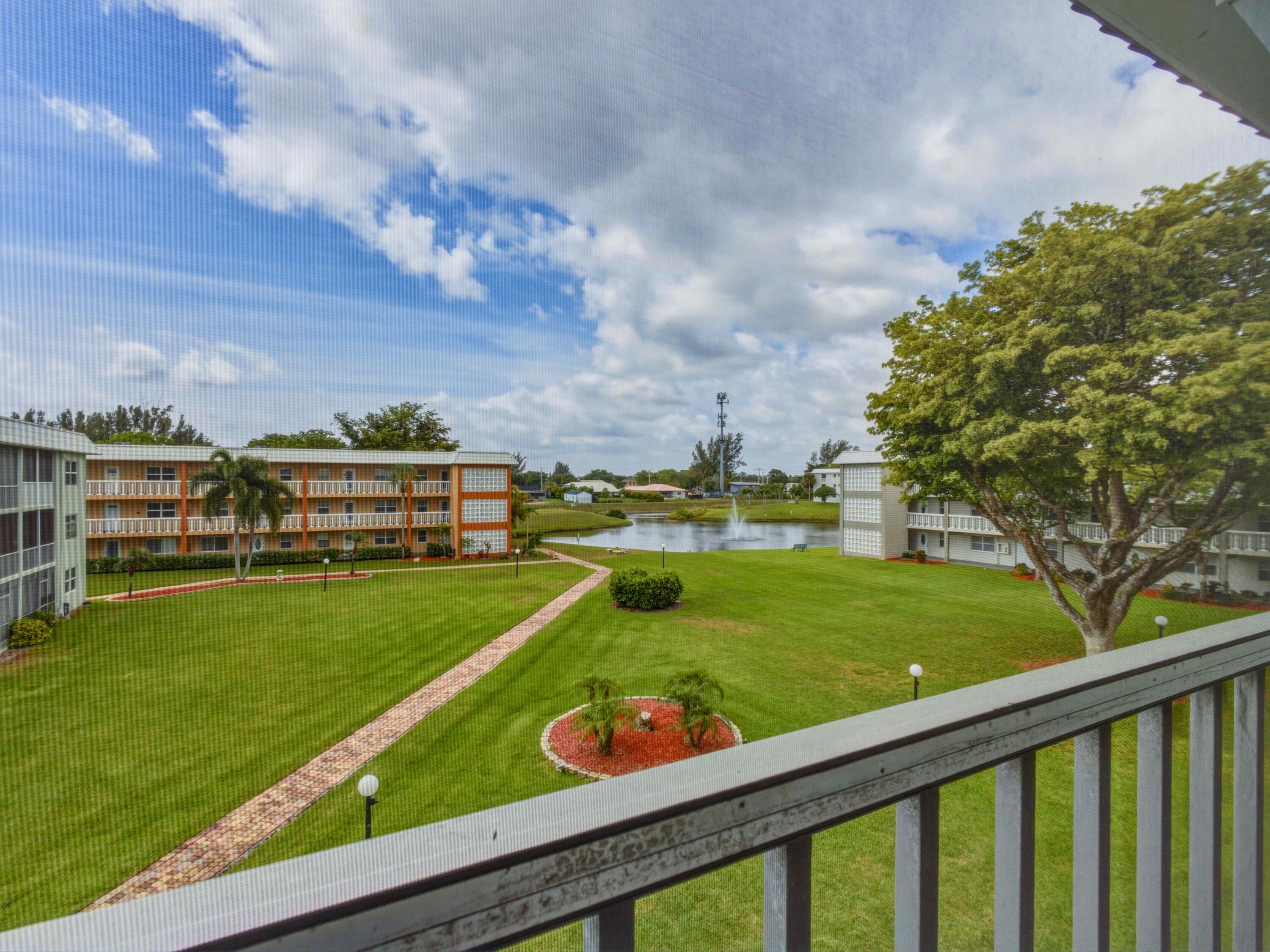 9810 Marina Boulevard, Unit 1136 Boca Raton, FL 33428 - Photo 17 of 35 a view of a swimming pool and a yard