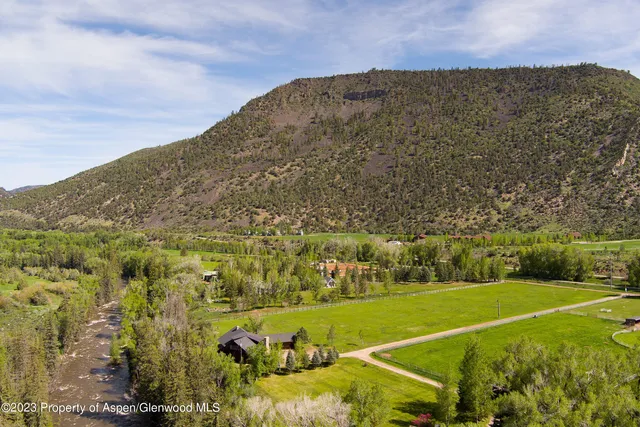 a view of a field with an trees
