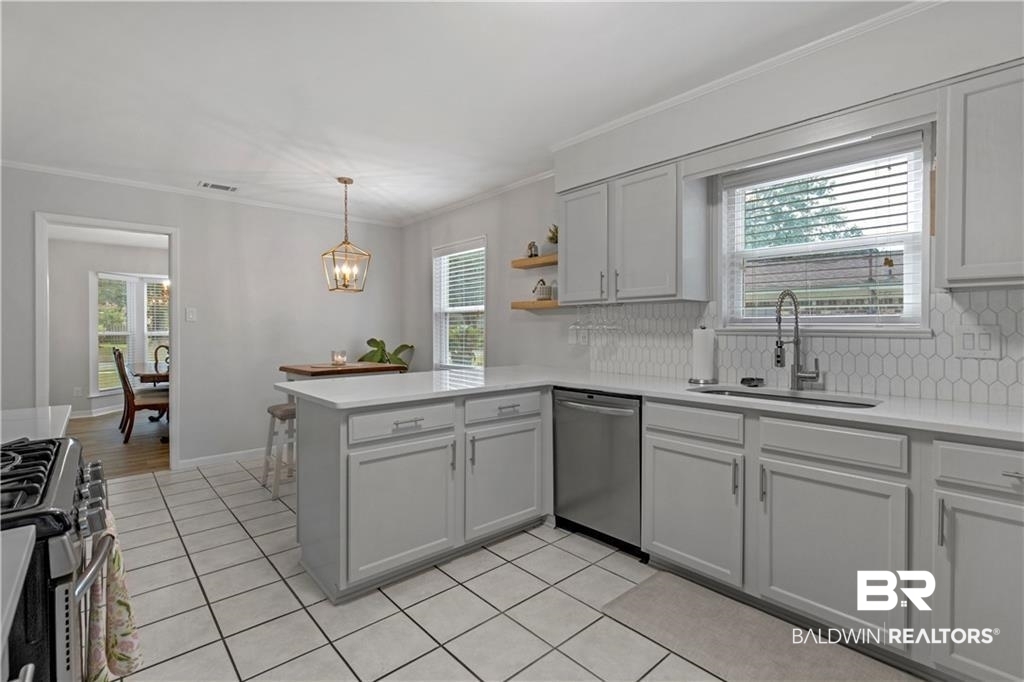 1624 Apex Drive Mobile, AL 36693 - Photo 15 of 29 Kitchen featuring a healthy amount of sunlight, appliances with stainless steel finishes, and sink