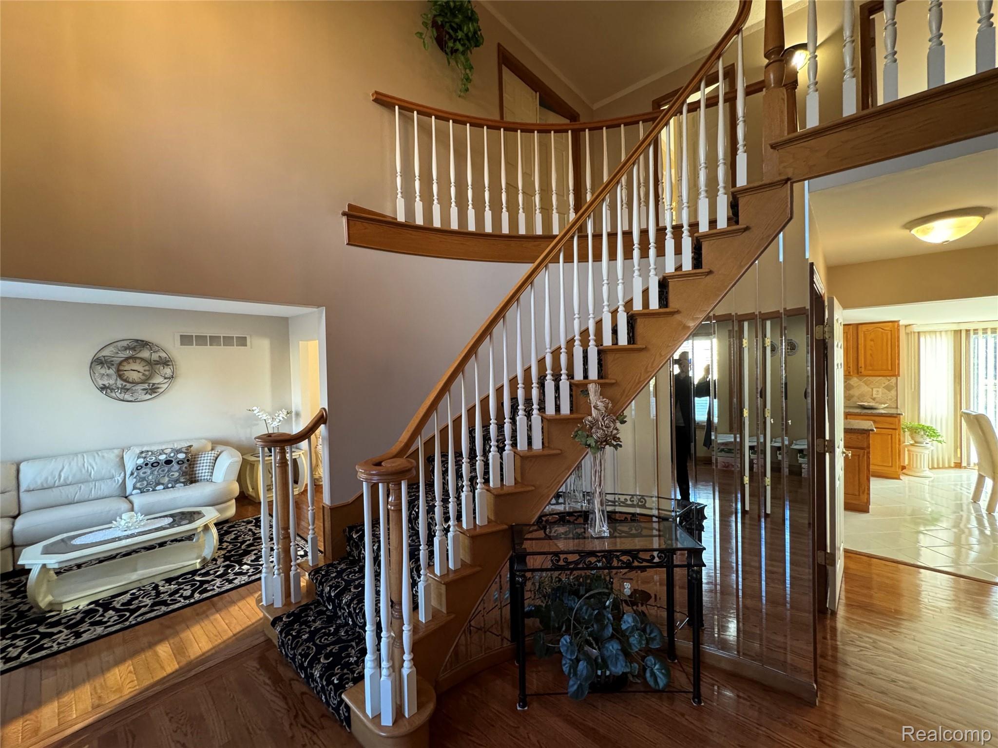 48583 Tilch Road Macomb, MI 48044 - Photo 20 of 53 Staircase featuring wood finished floors and a high ceiling
