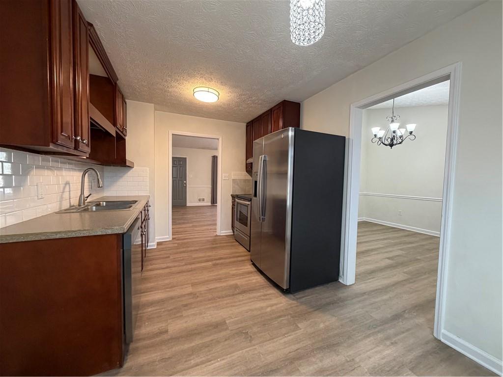 3056 Mill Falls Court Duluth, GA 30097 - Photo 12 of 31 a kitchen with stainless steel appliances a refrigerator and a sink