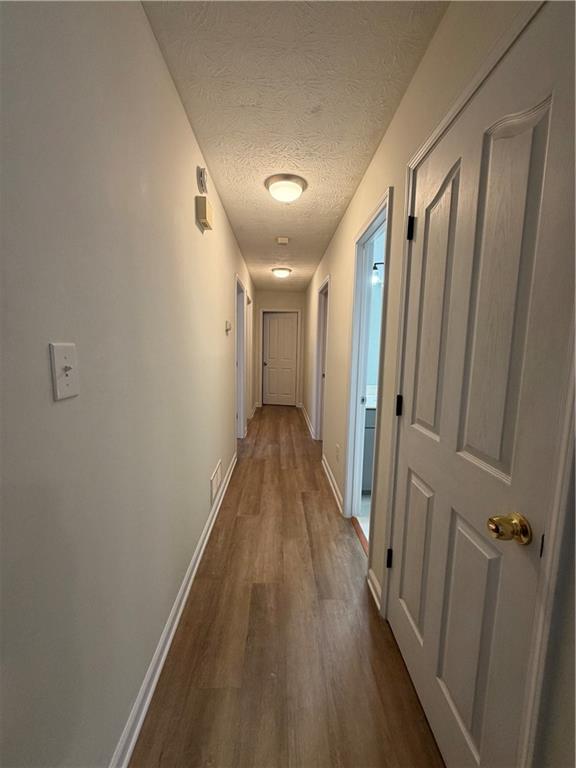 3056 Mill Falls Court Duluth, GA 30097 - Photo 14 of 31 a view of a hallway with wooden floor
