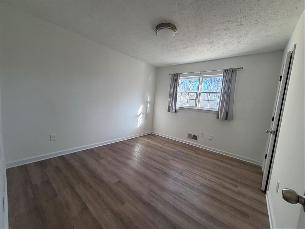 3056 Mill Falls Court Duluth, GA 30097 - Photo 15 of 31 an empty room with wooden floor and windows