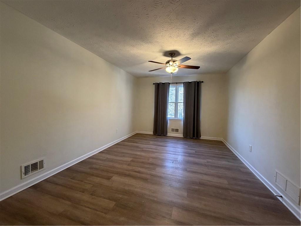 3056 Mill Falls Court Duluth, GA 30097 - Photo 18 of 31 a view of an empty room with a window and wooden floor