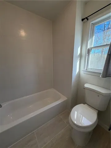 a bathroom with a toilet and a bathtub