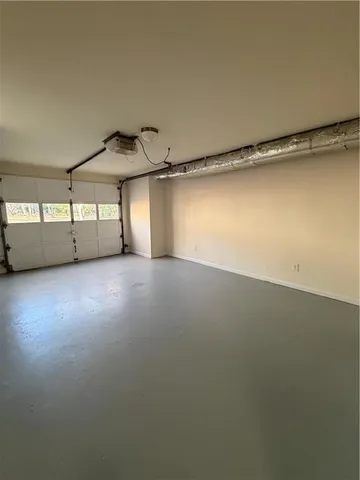 an empty room with a empty space and windows